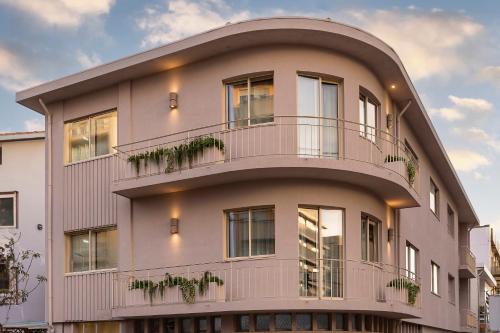 a building with balconies and plants on it at Ocean Boutique Guesthouse in Matosinhos