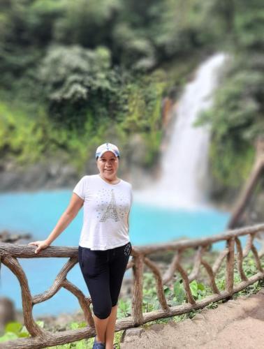 a woman standing on a bridge in front of a waterfall at Casa la Labrador in El pilon