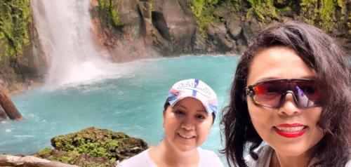 two women standing in front of a waterfall at Casa la Labrador in El pilon