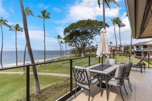 a patio with a table and chairs and the ocean at WAILEA ELUA, #1304 condo in Wailea