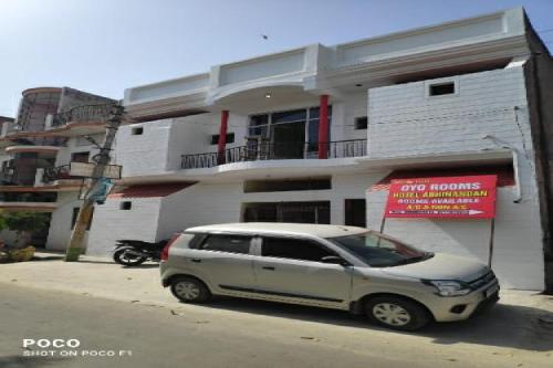 a white suv parked in front of a building at SPOT ON Hotel Abhinandan in Meerut