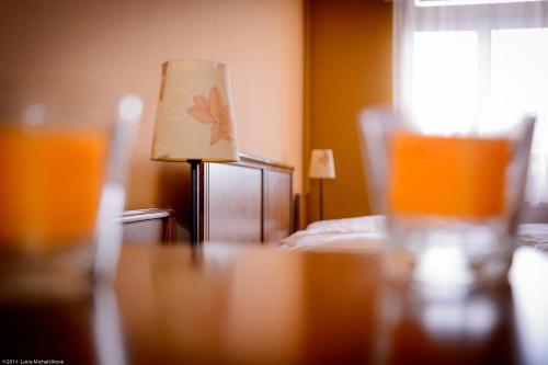 a bedroom with a bed and a table with a lamp at Penzion Pod Kašnou in Frýdek-Místek