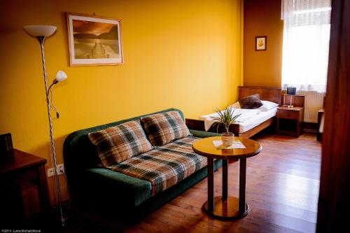 a living room with a couch and a table at Penzion Pod Kašnou in Frýdek-Místek