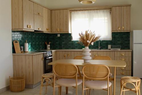 a kitchen with wooden cabinets and a table and chairs at Dry martini in Myrina