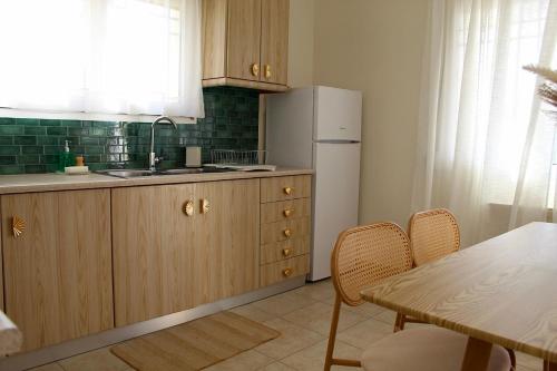 a kitchen with a refrigerator and a table with chairs at Dry martini in Mirina