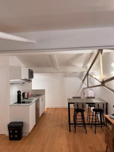 une cuisine et une salle à manger avec une table et des chaises dans l'établissement Loft Moderne, à Poitiers