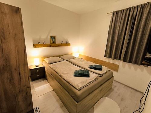 a small bedroom with two beds and a window at Apartments for families with children Jasenak, Karlovac - 23804 in Jasenak