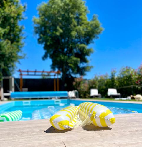 two yellow and white inflatablechairs sitting on a table near a pool at Casa da nascente douro in Paços de Gaiolo