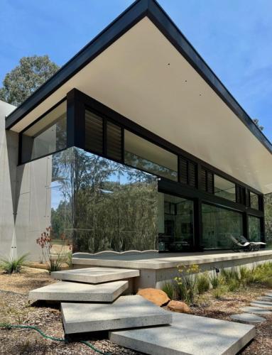 a modern house with a large glass facade at Huzzah! in Theresa Park
