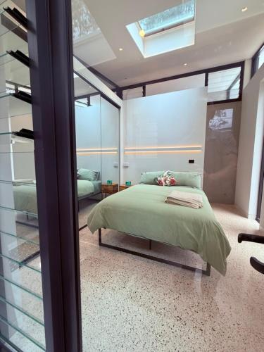 a bedroom with a bed and a glass wall at Huzzah! in Theresa Park