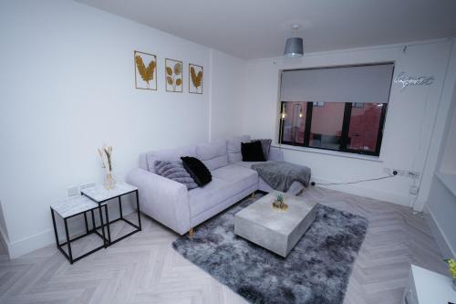 a living room with a couch and a table at 2 Bed Apartment - Bham City Centre, Next to Utility Arena - Free Parking! in Birmingham