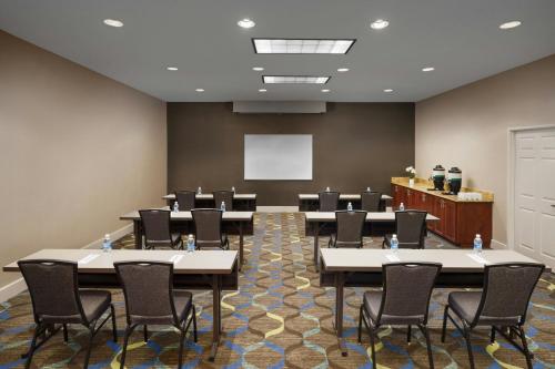 a conference room with tables and chairs and a whiteboard at Residence Inn Arlington in Arlington