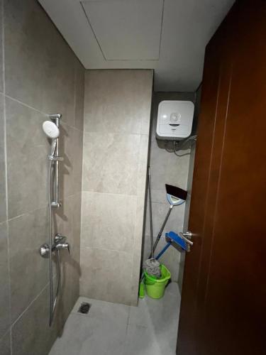 a small bathroom with a shower and a toilet at Masterstadt Batam Pollux Habibie A3 by Ocha in Bagam