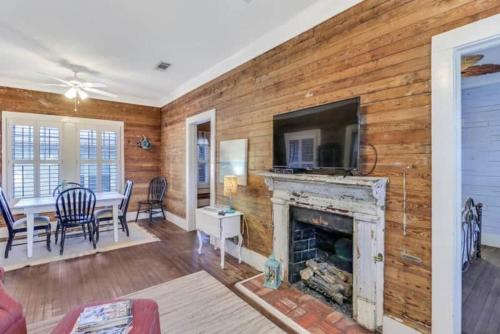 a living room with a fireplace and a television at Walk to the Beach! in Gulfport
