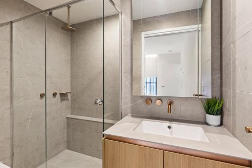 a bathroom with a sink and a shower at Lux Style Spacious 1 Bed Apt, Pool , Parking in Brisbane