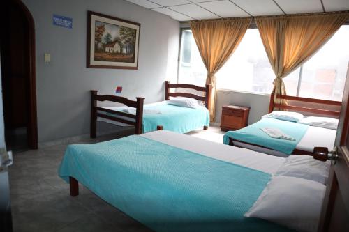 Postel nebo postele na pokoji v ubytování Hotel casa real