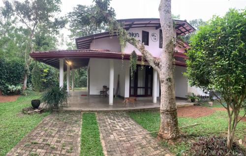 a house with a dog standing in front of it at Diya Villa-Boossa in Boossa