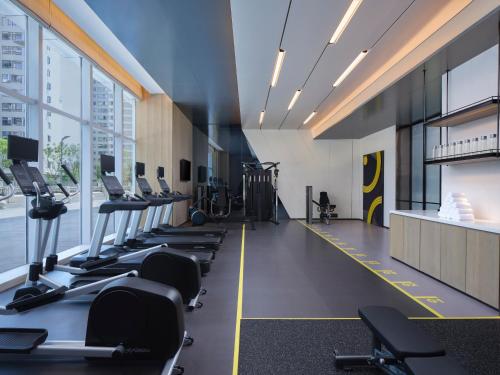 a gym with rows of treadmills and exercise bikes at AC Hotel by Marriott Chengdu North in Chengdu