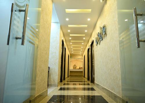 a corridor of a building with a hallway at Hotel O Glance Inn in Patna
