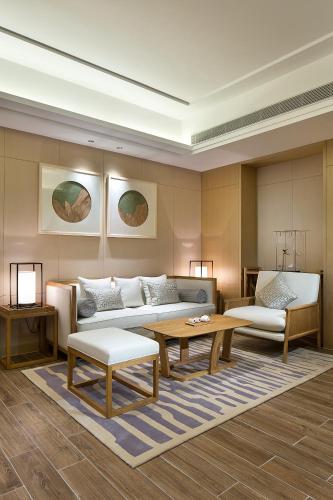 a living room with a couch and a table at Wyndham Grand Plaza Royale Wenchang in Wenchang