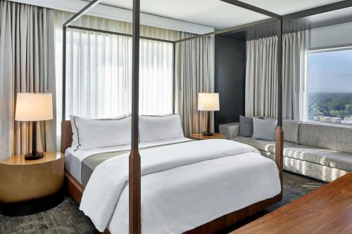 a bedroom with a large bed and a couch at The Westin Charlotte in Charlotte