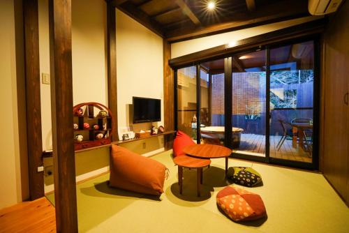 a living room with a table and a chair at 清水いにしえ庵 in Kyoto