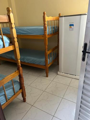 a room with a refrigerator and bunk beds at RoseMarAzul Temporadas in Cabo Frio