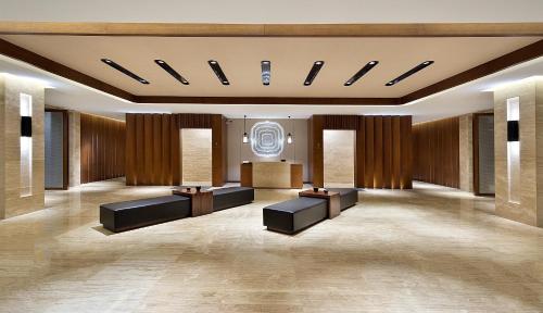 a lobby with couches and tables in a building at Wyndham Grand Plaza Royale Wenchang in Wenchang