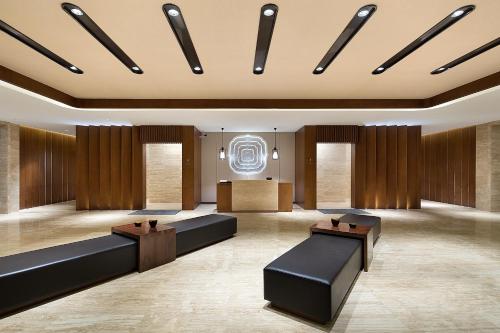 a lobby with couches and a podium in a building at Wyndham Grand Plaza Royale Wenchang in Wenchang