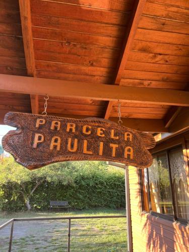 a sign hanging from the ceiling of a building at Parcela Paulita in Quillón