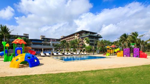 a resort with a playground and a pool at Wyndham Grand Plaza Royale Wenchang in Wenchang