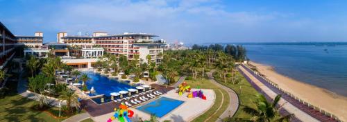 an aerial view of a resort with a pool and a beach at Wyndham Grand Plaza Royale Wenchang in Wenchang