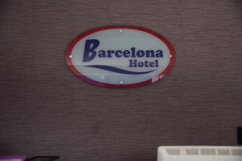 a sign for a barcelona hotel on a wall at Hotel Barcelona in Montería