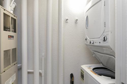 a washing machine in a room with a mirror at River Pines A303 condo in Edwards