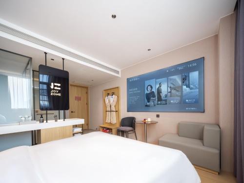 TV a/nebo společenská místnost v ubytování 桔作酒店（郑州经开中原福塔东地铁站店）