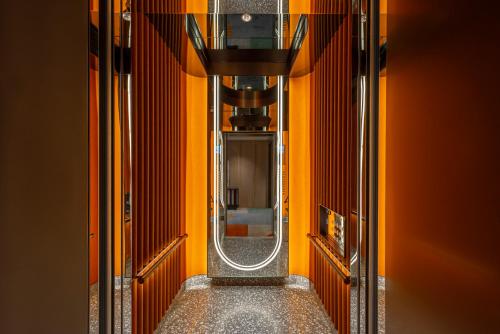 a hallway of a train with a mirror on it at 采寓halo house in Taichung