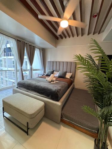 a bedroom with a large bed and a ceiling fan at Casa de gloria in Davao City