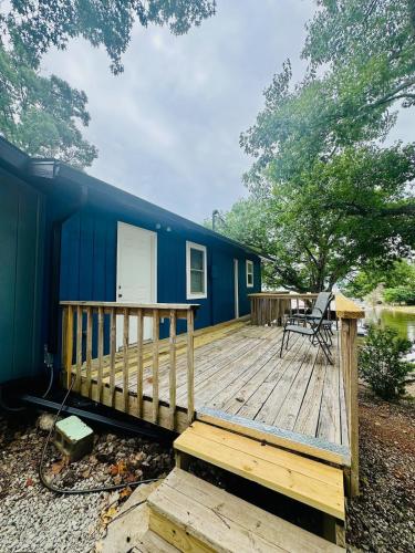 a blue tiny house on a wooden deck at The whole family in Sunrise Beach