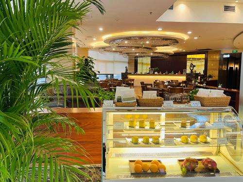a bakery with a display case filled with fruit at Chengdu Joyhub Cheer Hotel in Shuangliu