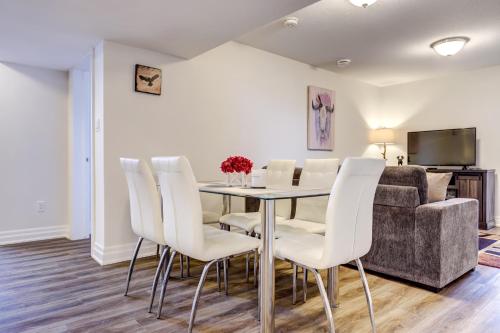 a dining room with a table and white chairs at GLOBALSTAY New houses near Huron Lake in Port Elgin