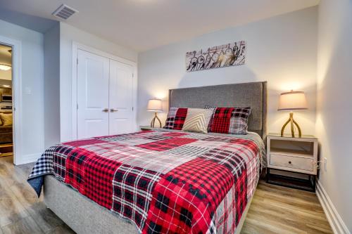 a bedroom with a bed with a plaid blanket at GLOBALSTAY New houses near Huron Lake in Port Elgin