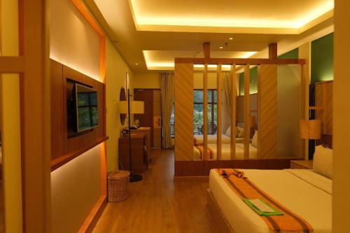a bedroom with a bed and a large mirror at Khas Parapat in Parapat