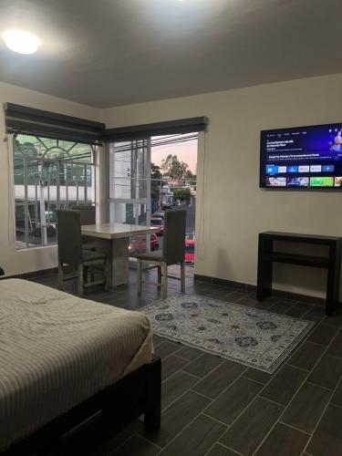 a bedroom with a bed and a desk and a tv at Departamento Zona Hospital in Zamora de Hidalgo