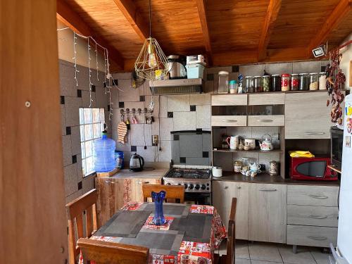 a kitchen with a table and a stove top oven at Casa Isis in Constitución