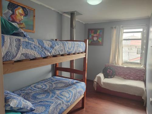 a bedroom with two bunk beds and a window at Casa Isis in Constitución