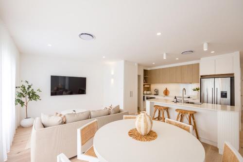 a kitchen and living room with a table and a couch at Olas Villa 6 - Plunge Pool & Walk to Beach in Anna Bay