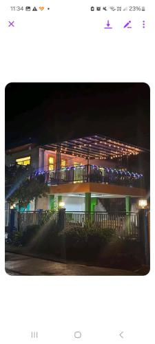 a lit up building with a balcony at night at Estefania Homestay in Santa Monica
