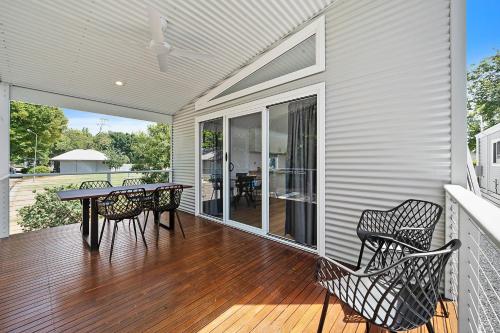 a patio with a table and chairs on a deck at Myrtleford Holiday Park in Myrtleford