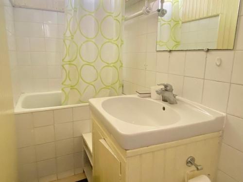 une salle de bain avec un lavabo, un miroir et une baignoire dans l'établissement Maison proche plage à Locmaria, 3 chambres - FR-1-813-18, à Groix