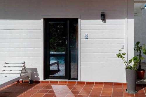a door to a house with a bench next to it at Estancia Florencia Hab 6 in Tela